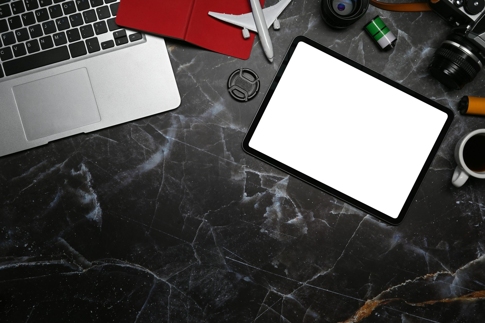 Top view computer laptop, digital tablet and retro camera on marble background.